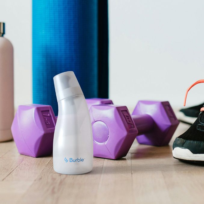 Burble nasal irrigation bottle next to workout equipment